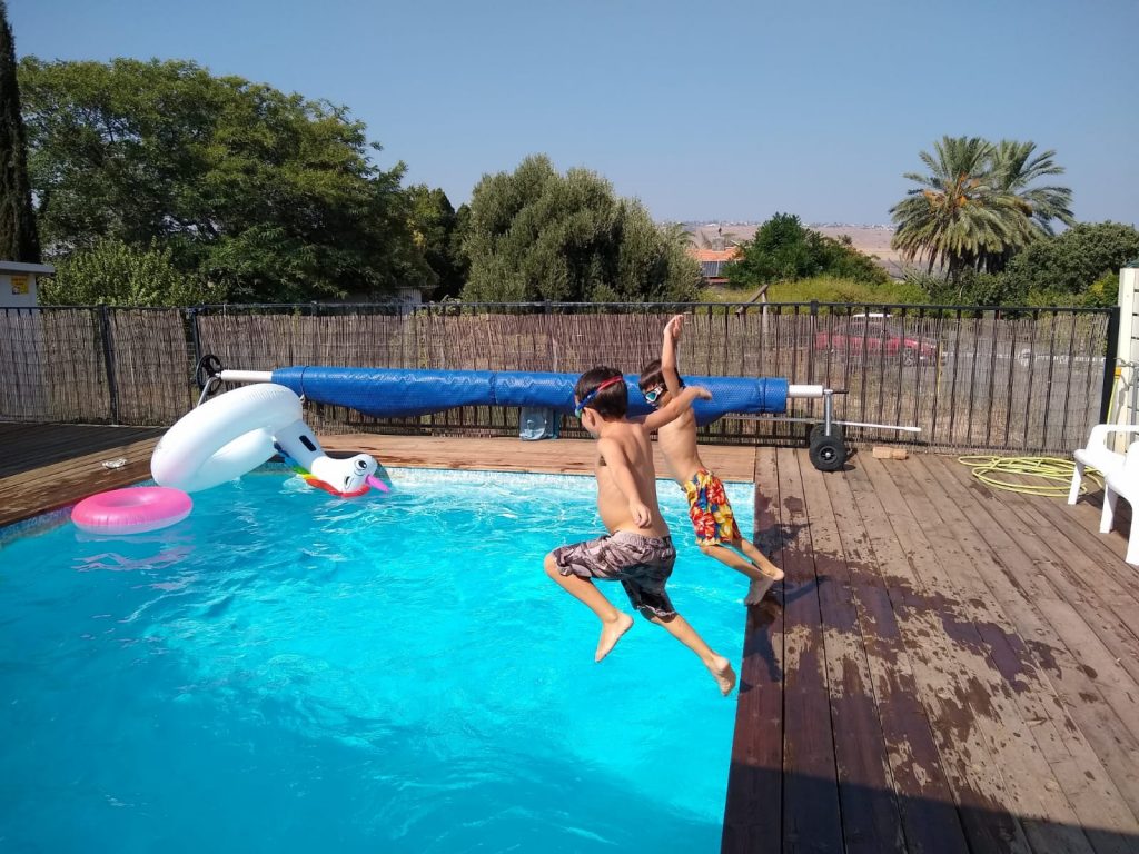 Kids jumping into pool